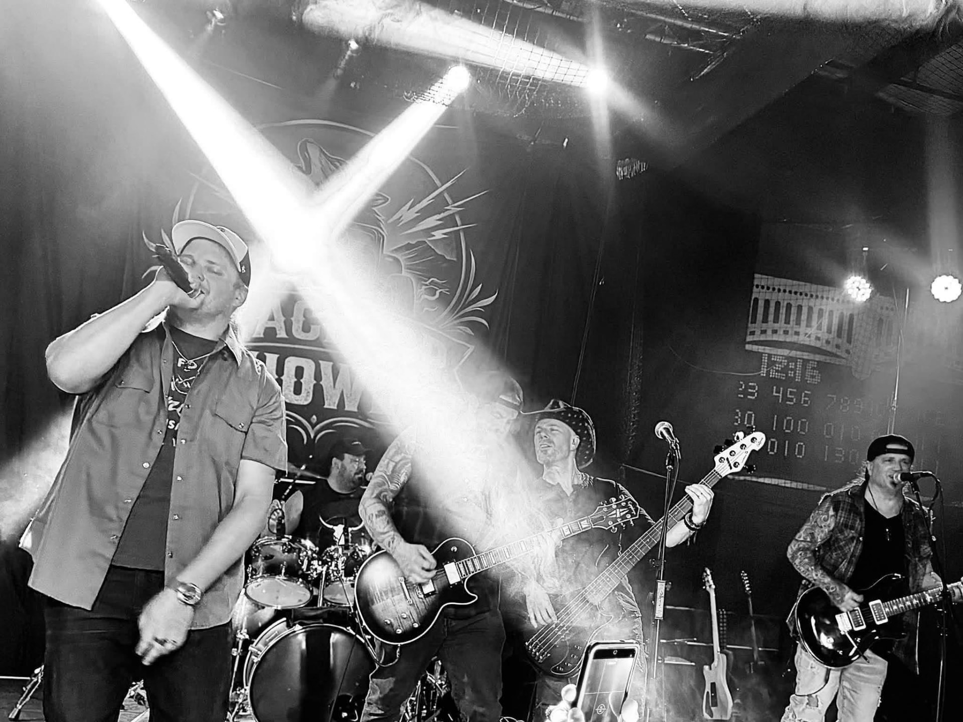 Blacktop Howl mid-set with spotlights crossing the stage